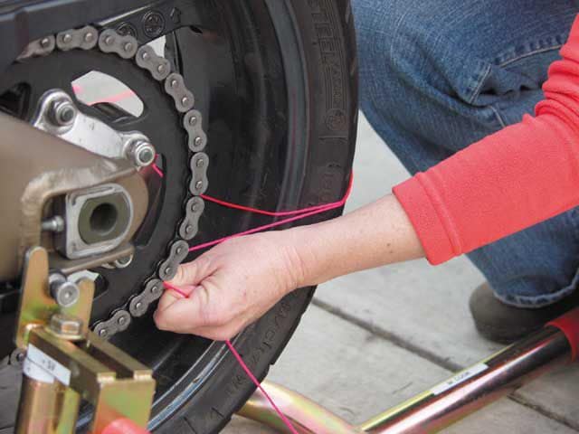 Check motorcycle wheel alignment with string 1