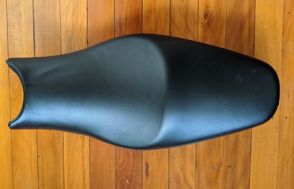 final motorcycle reupholdering, with vinyl stretched correctly over the seat