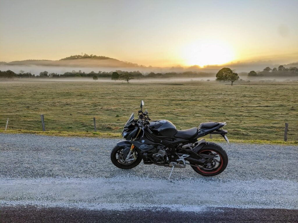 Riding my BMW S1000R at dawn in a misty valley