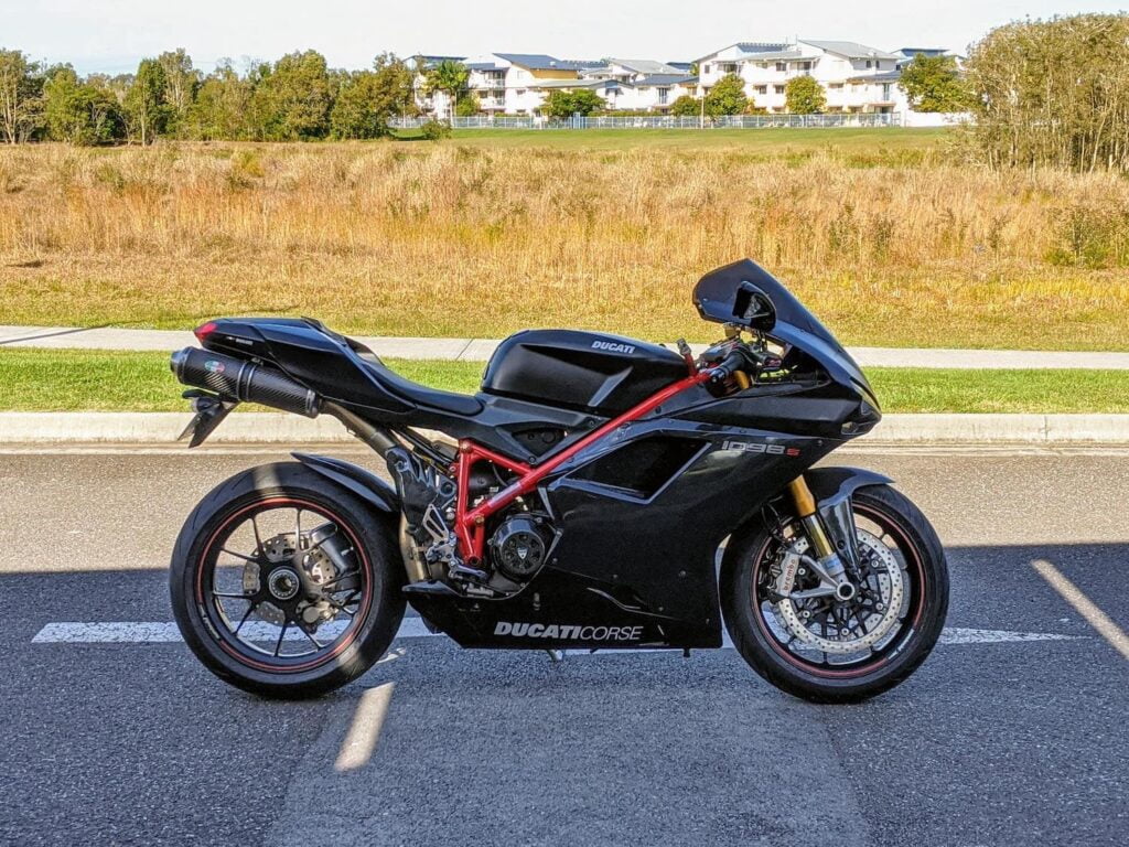 Black and red ducati 1098S parked on side of car park