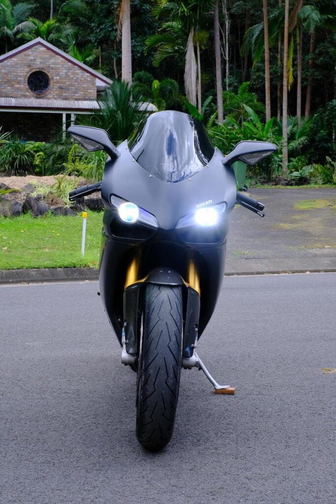Front view of a Ducati 1098S with both low beam and high beam headlight on