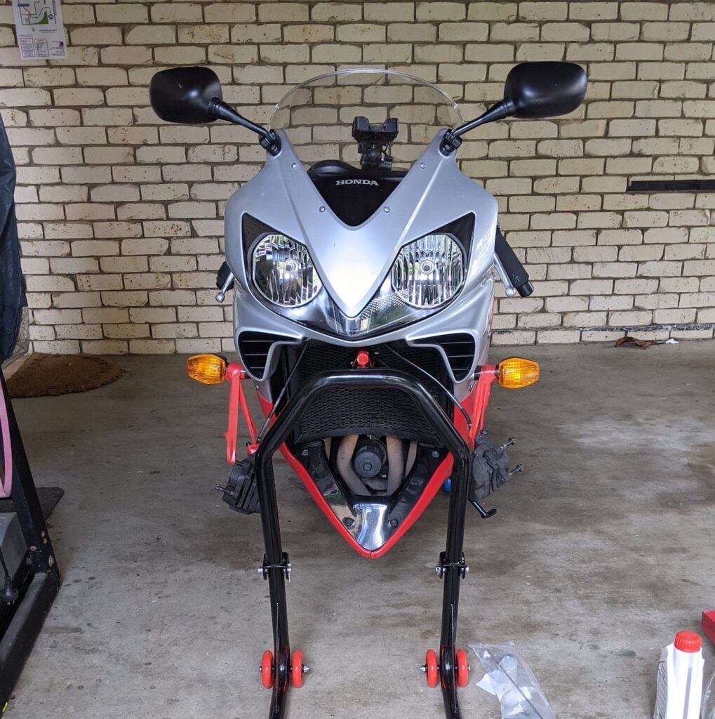 Motorcycle with removed front forks, up on a triple tree stand