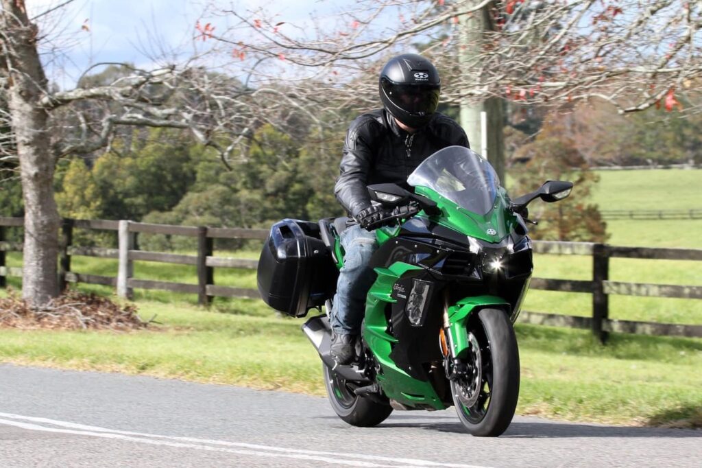 Riding position of the 2018 Ninja H2 - comfortable and upright. Green scenery in background