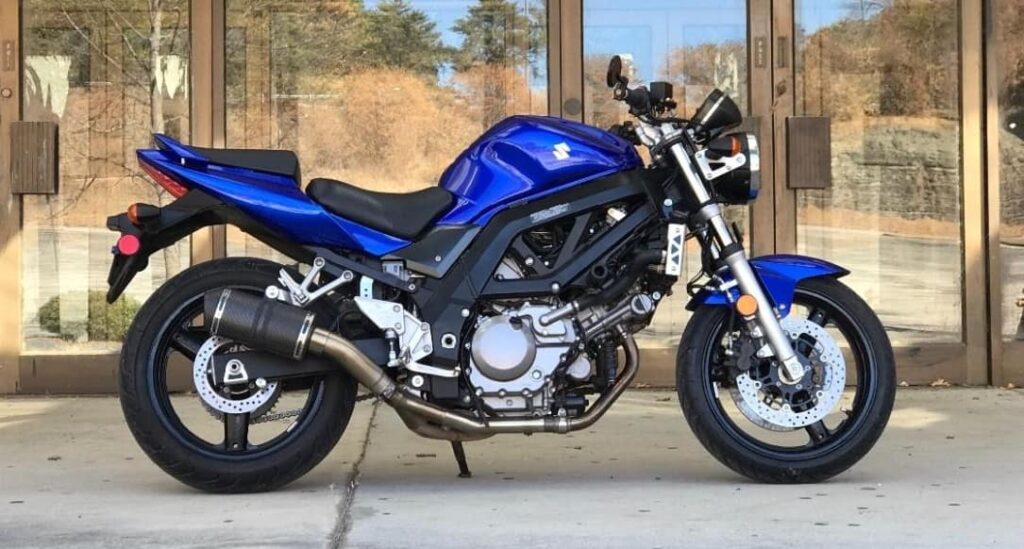 Naked blue second generation Suzuki SV650, custom exhaust