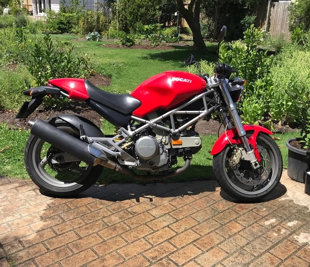 Ducati 620 in pool of water - example of bad motorcycle photography.