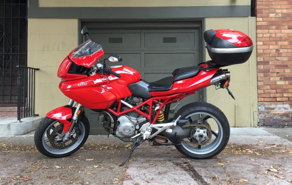 Ducati Multistrada 1000ds with top box parked in front of garage