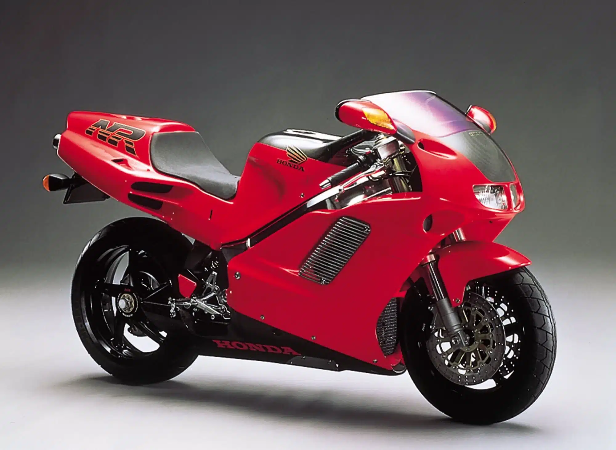 All the V4 Motorcycles You Can Buy New or Used (2026) 21 1992 Honda NR750 red V4 motorcycle, right-front studio view