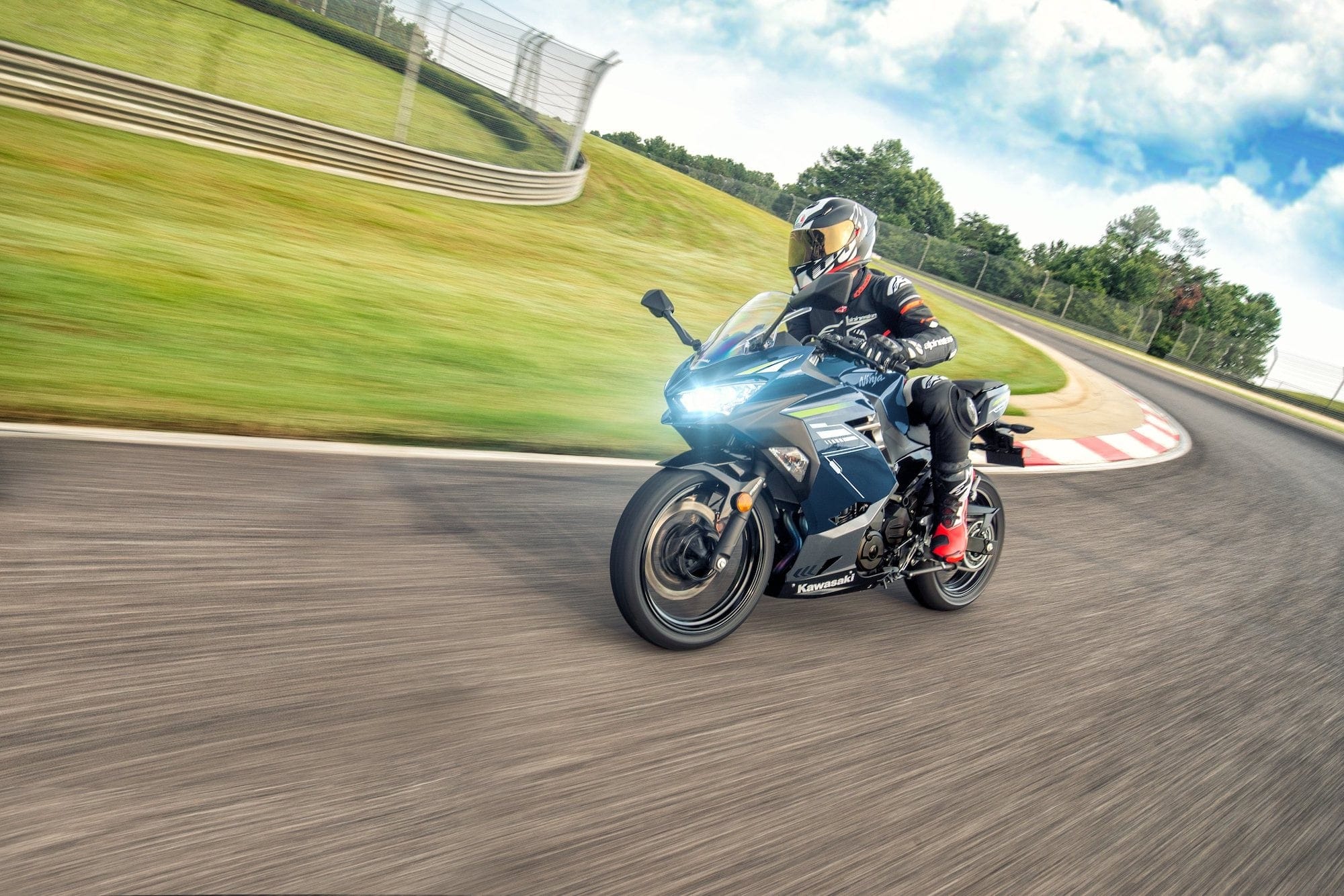Kawasaki Ninja 300, 400, Ninja 500, Z300, Z400, and Z500 — Complete Buyer’s Guide 17 Rider cornering a 2022 Kawasaki Ninja 400 on a racetrack