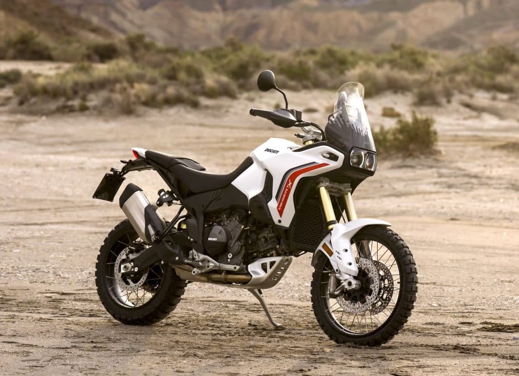 Ducati DesertX Buyer's Guide 2 2026 Ducati DesertX V2 parked in a rocky desert, right-front view