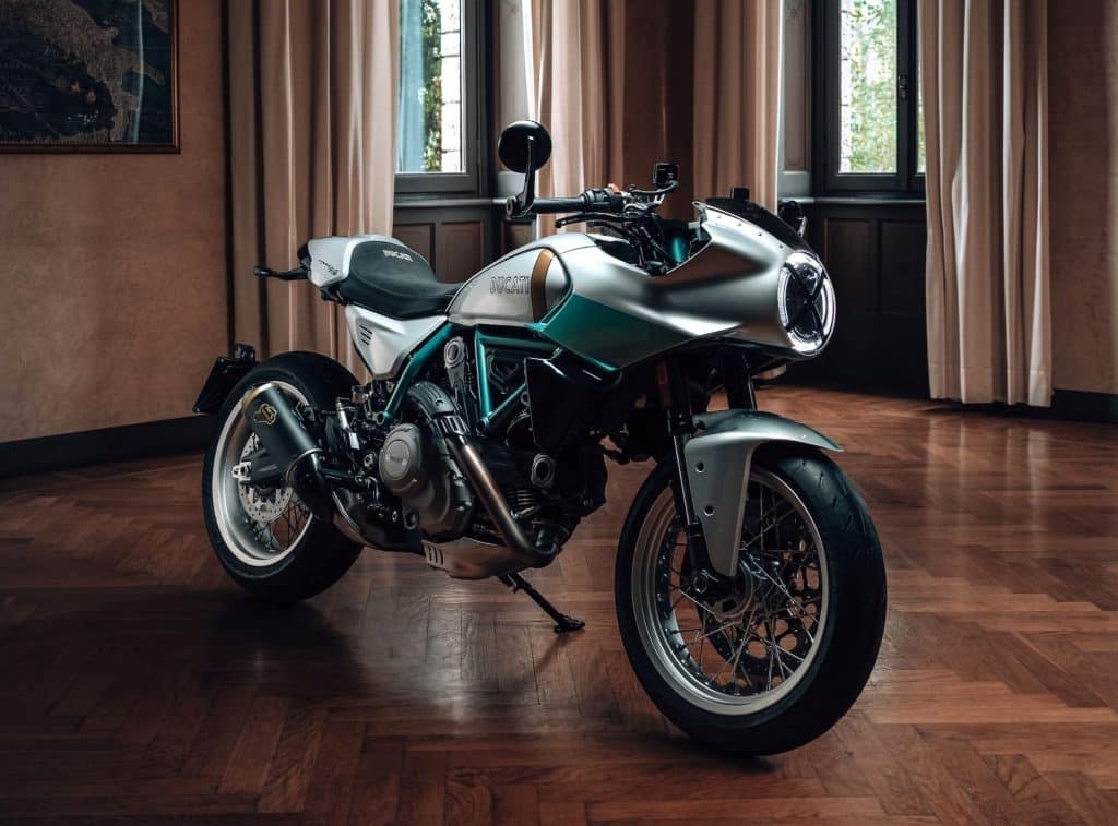 I want to be rich so I can have toys like the Ducati Formula 73 1 2026 Ducati Formula 73 in silver and green, photographed in a living room