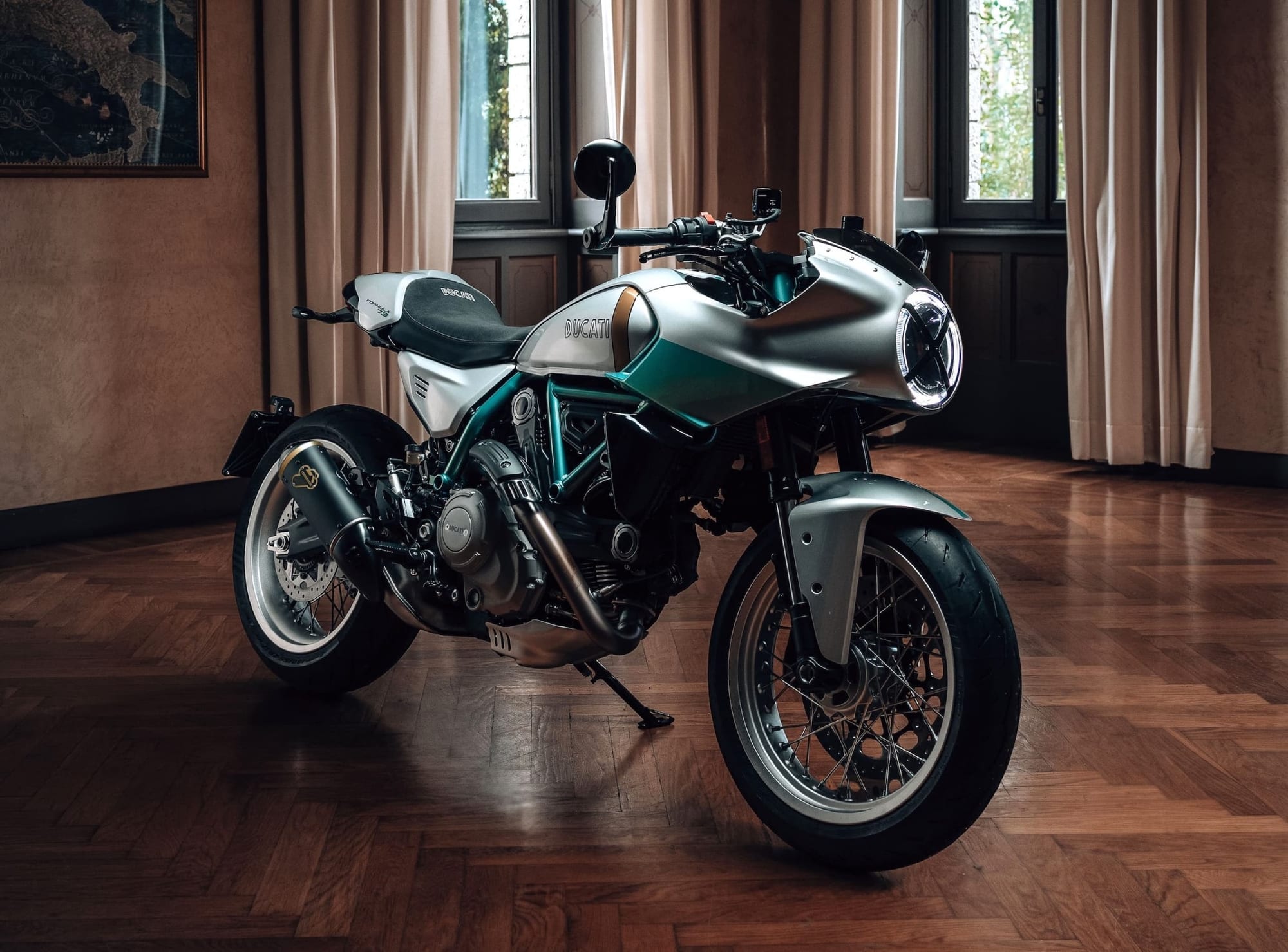 Best-Looking Motorcycles of 2026 — Just, Like, My Opinion, Man 3 2026 Ducati Formula 73 in silver and green, photographed in a living room