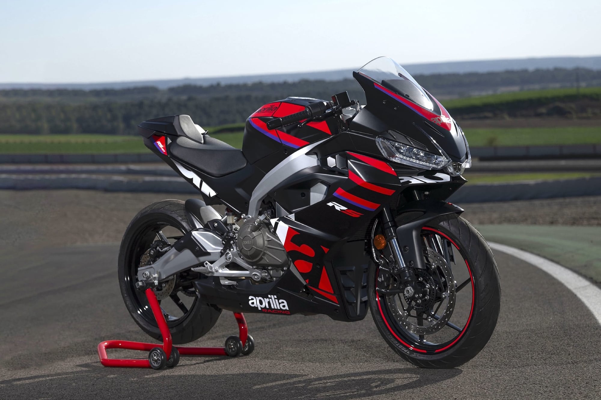 Aprilia RS 457 — More than the Sum of its Parts 6 Aprilia RS 457 Racing Stripes on a paddock stand at a circuit