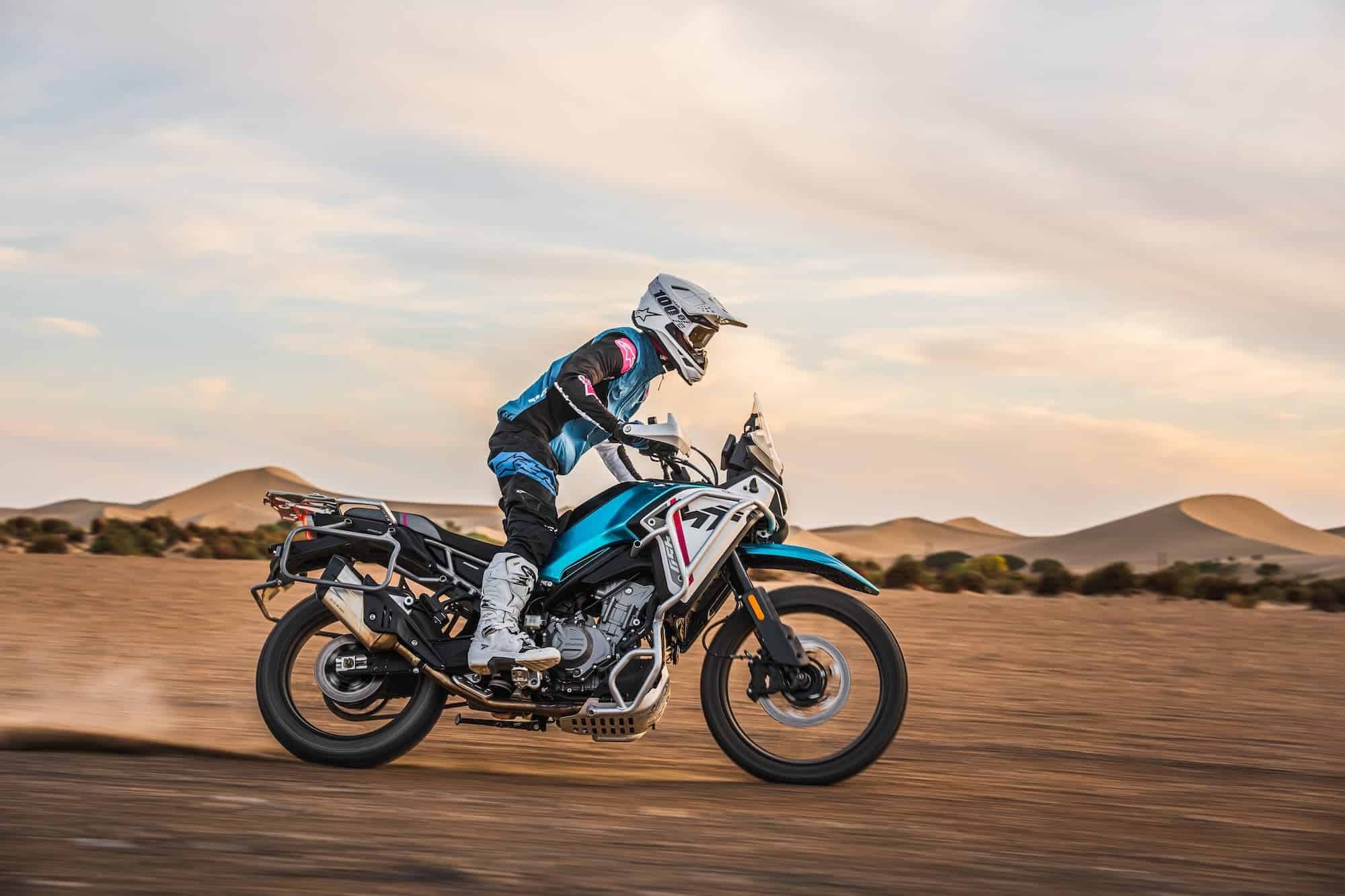 CFMOTO 450MT Review — Popular for a Reason 10 CFMOTO 450MT ridden across desert sand from the right side