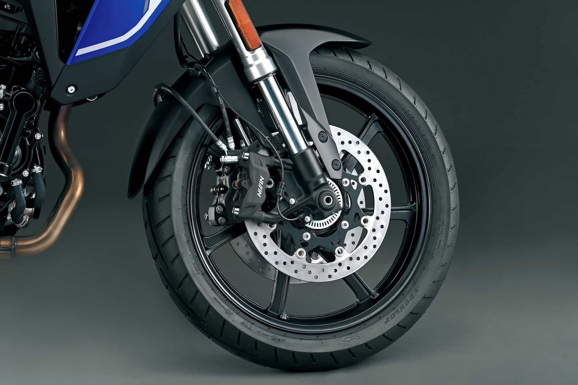 Suzuki V-Strom 800 Buyer’s Guide — RE vs DE, Engine, and Alternatives 6 Close-up of V-Strom 800RE radial four-piston Nissin front brake caliper and cast wheel