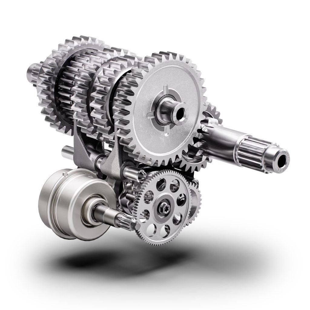 Automatic Motorcycle Transmissions Compared: DCT, AMT, E-Clutch and More 1 2025 KTM AMT transmission assembly showing the fixed gear pairs and selector hardware