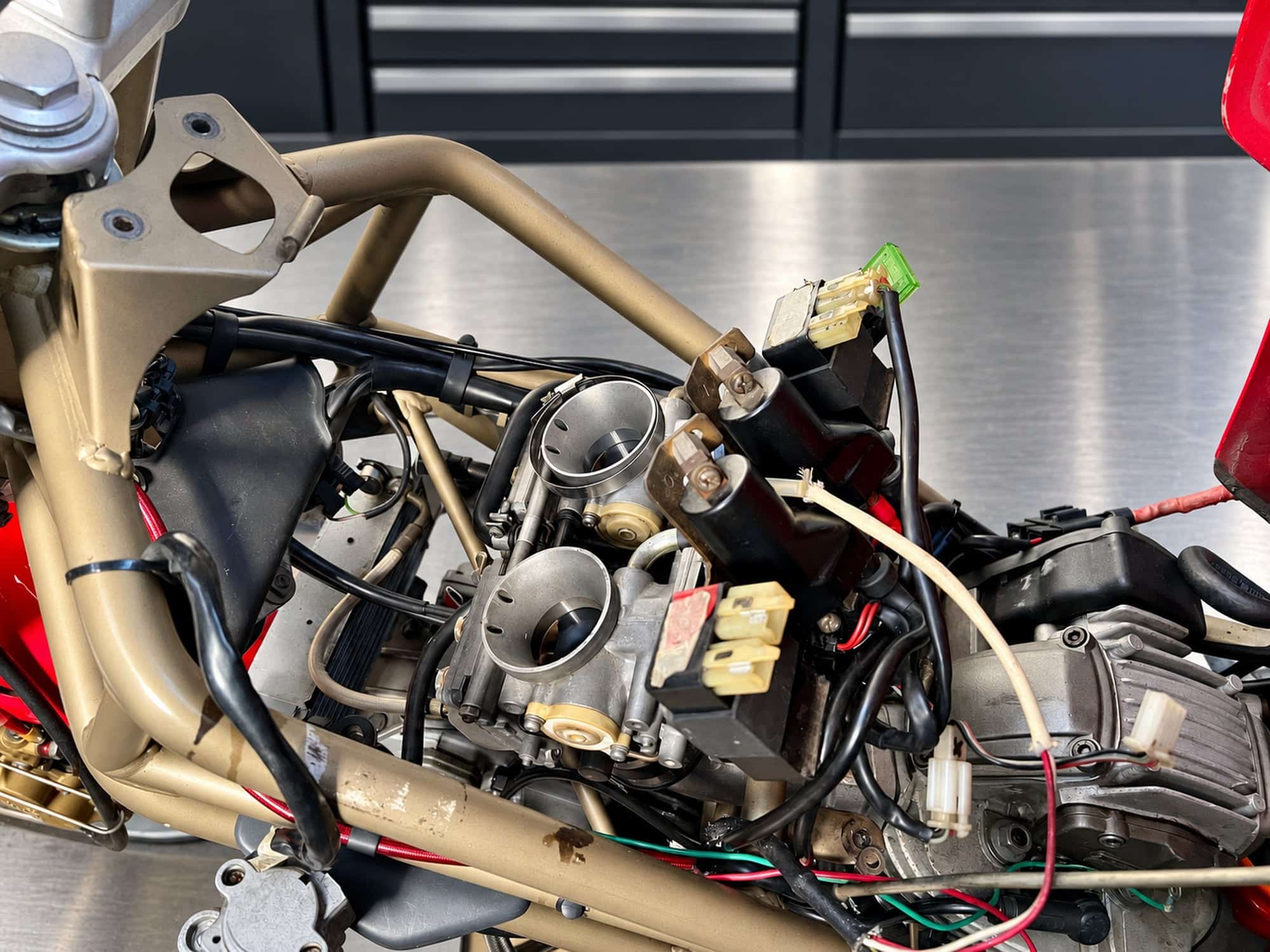 The Case for Carburettors in Motorcycles 5 Mikuni carburettors installed between the frame rails of a Ducati Monster M900